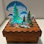 Fantastical forest scene with large mushrooms that tower over fir trees and many smaller plants. A deer peaks from within.